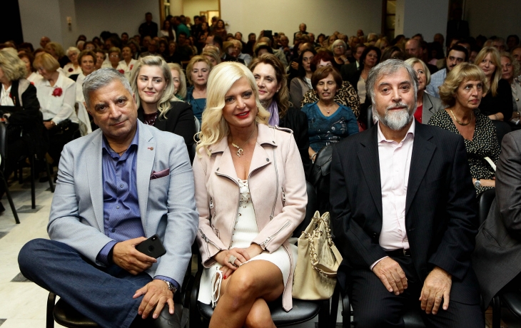 A room full of people watching the ceremony